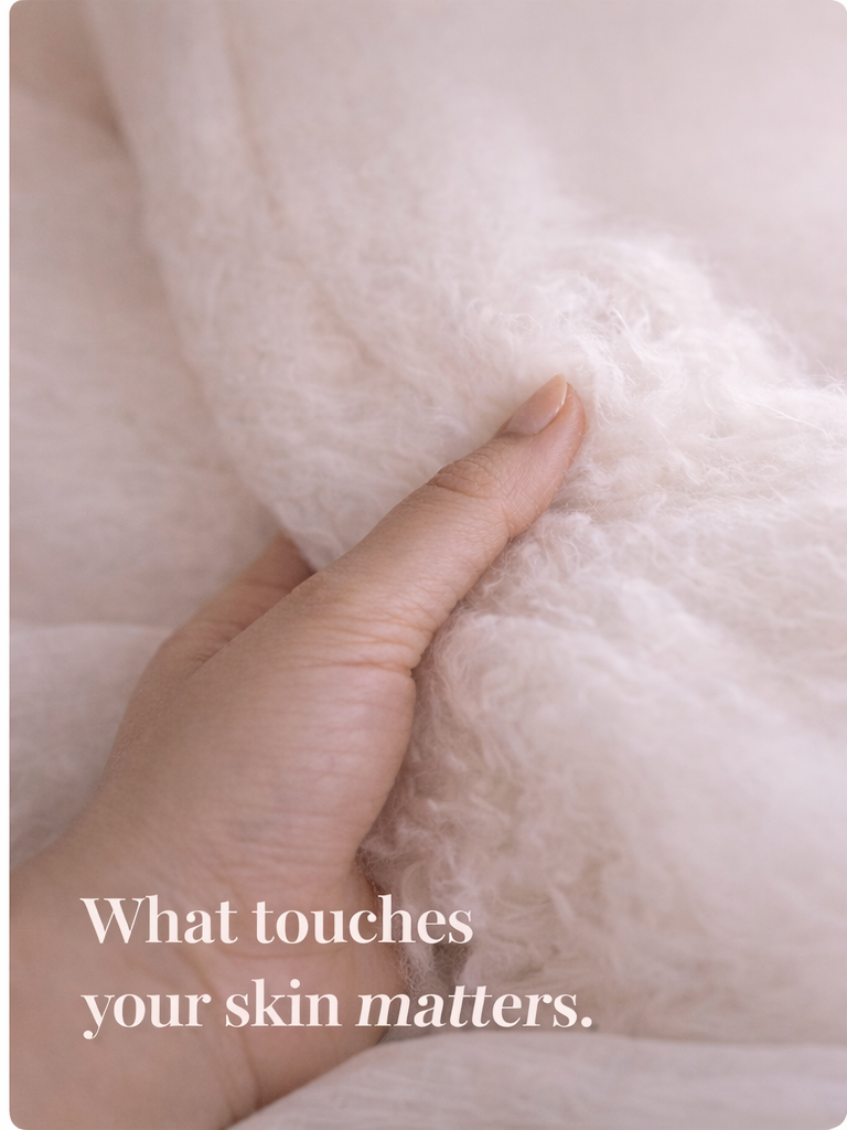 Hand touching soft organic cotton — what touches your skin matters