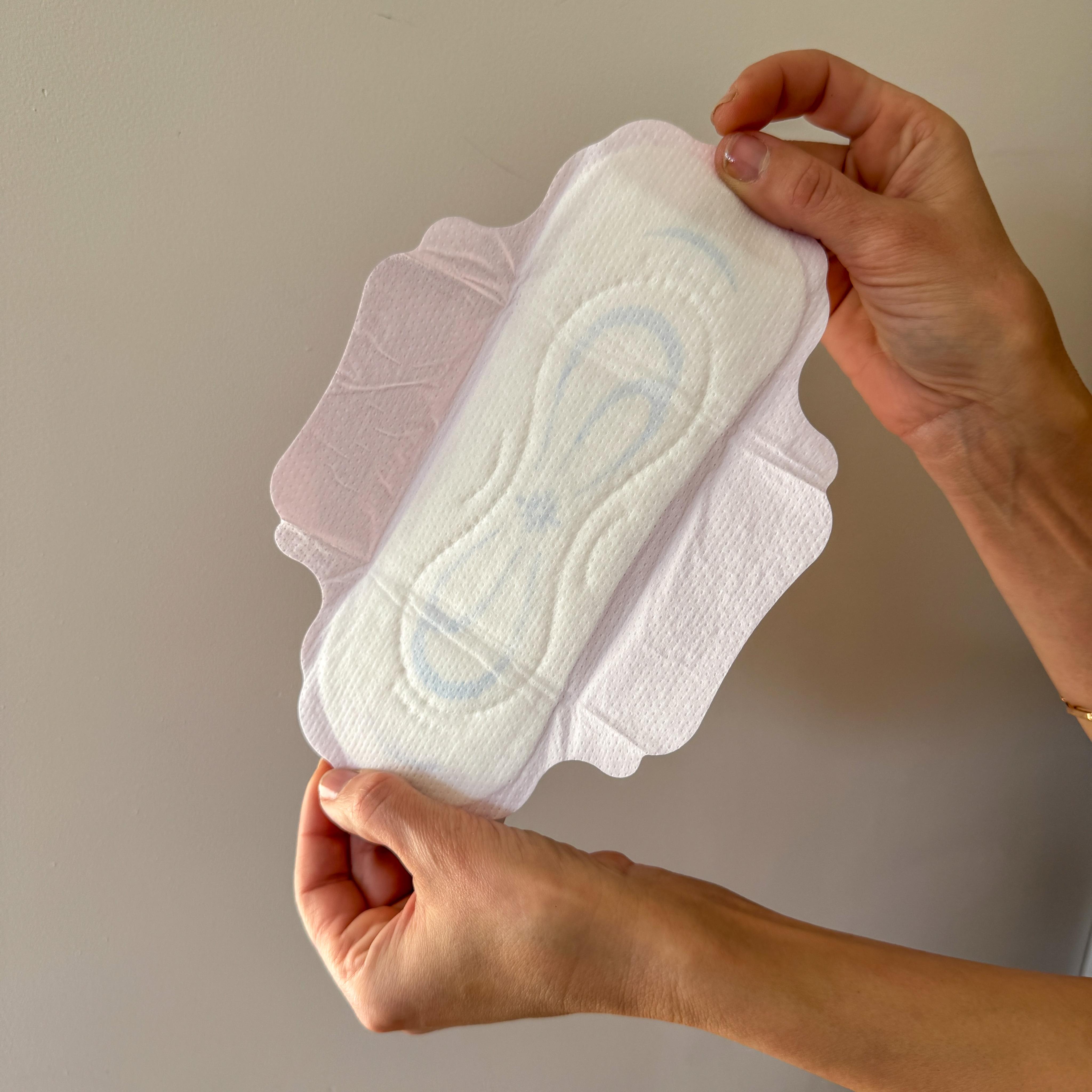 Soft organic cotton pad held gently in two hands — what touches your skin matters